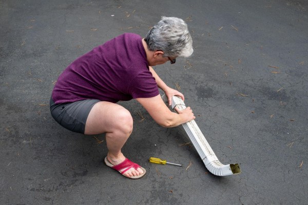 woman assembling gutter sections