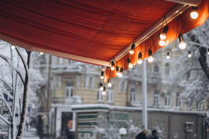 red awning with hanging lights in winter