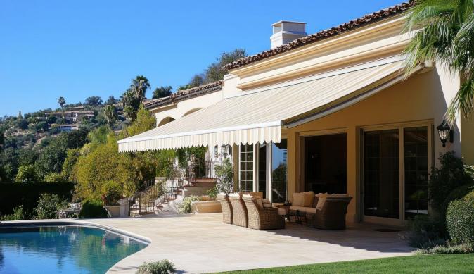 striped awning protecting backyard furniture on a sunny day